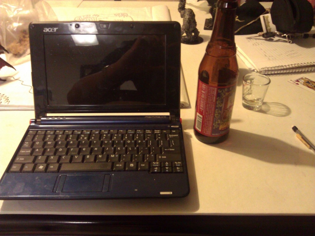 Here's the little Acer with a beer bottle (and a shot glass) for scale. It is tiny!